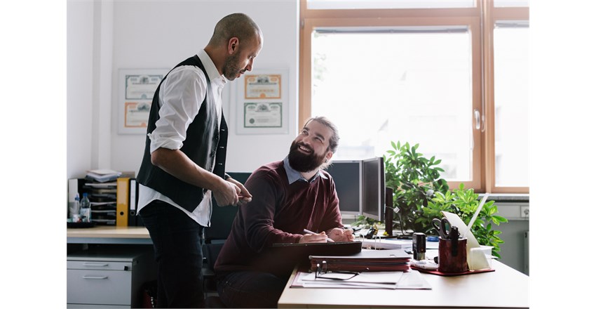 Business - 2 men talking in office desk.jpg